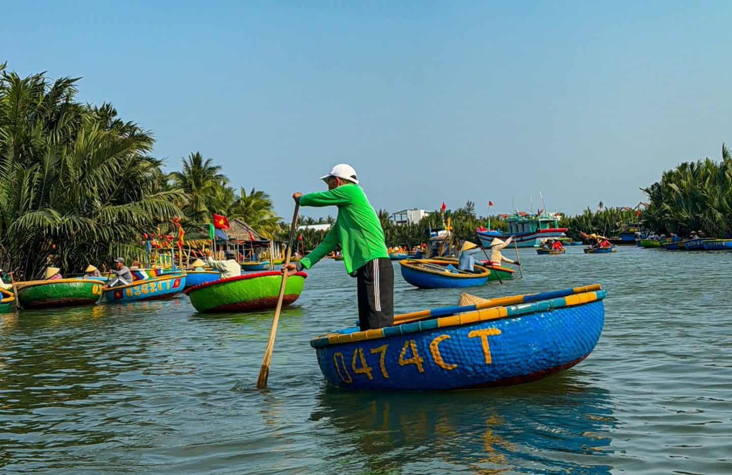 Vietnamese local rowing a basket boat in coconut forest Hoi An