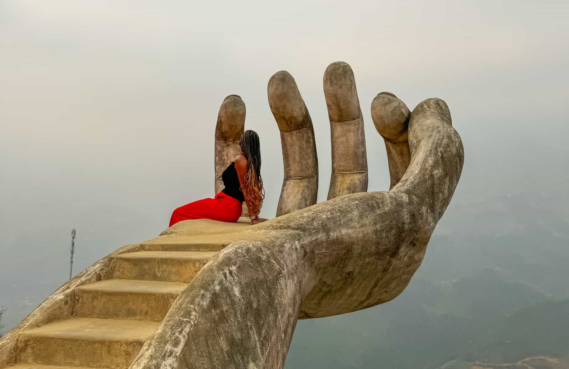 Sitting on a giant hand at Moana Sapa