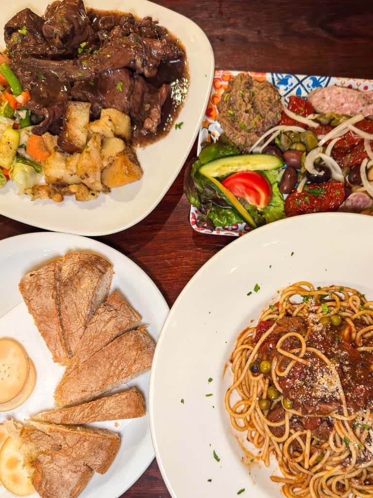 Assorted Maltese dishes including rabbot stew, cold platter plantains, and spaghetti with rabbit sauce.