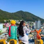 Nma Okafor enjoying the view of a colorful cityscape in South Korea with mountains in the background.